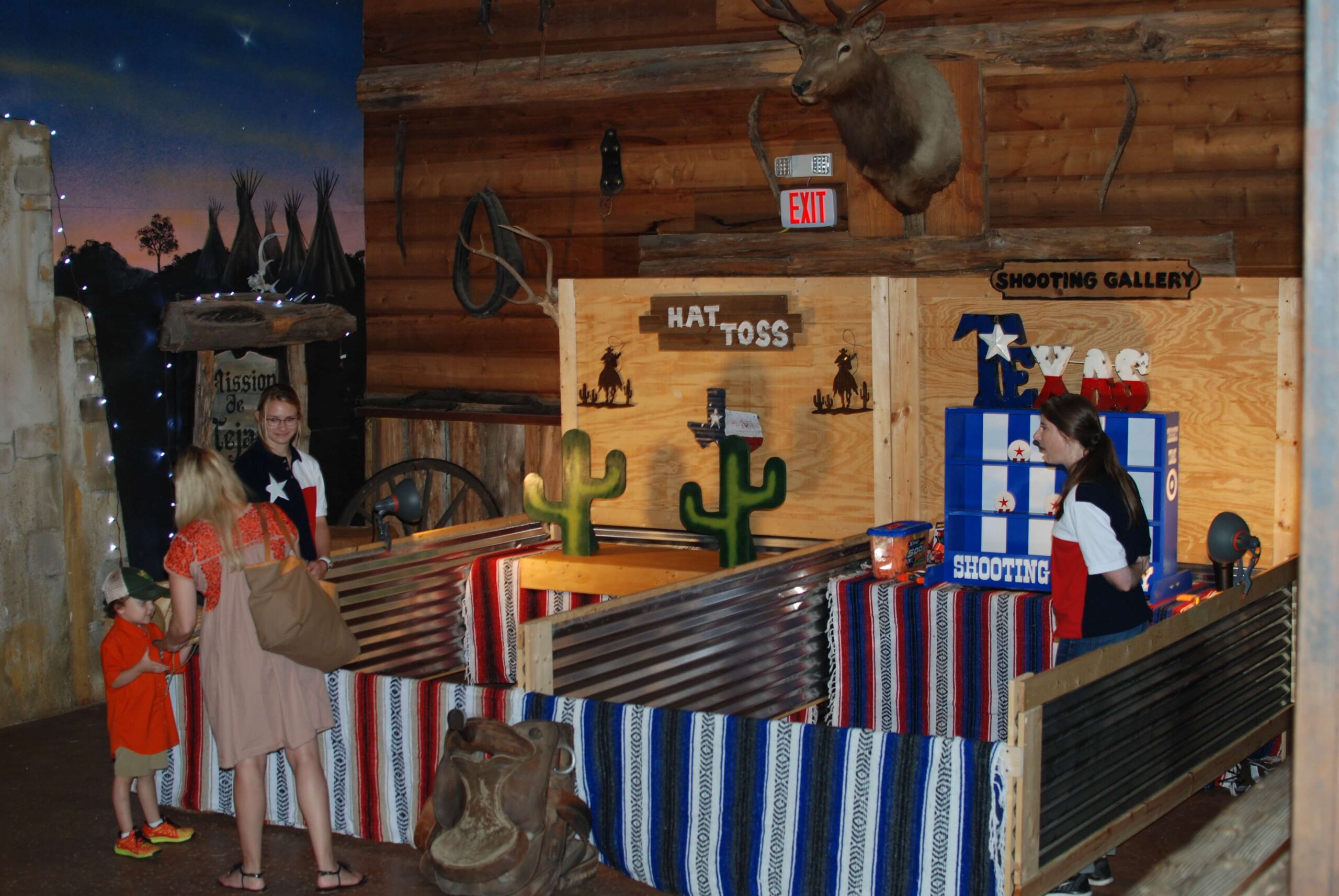 Company picnic guests enjoying western carnival booths at Enchanted Springs Ranch